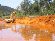 Shovel removing sludge